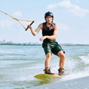 wakeboarding in the uk - man wakeboarding holding the tow line