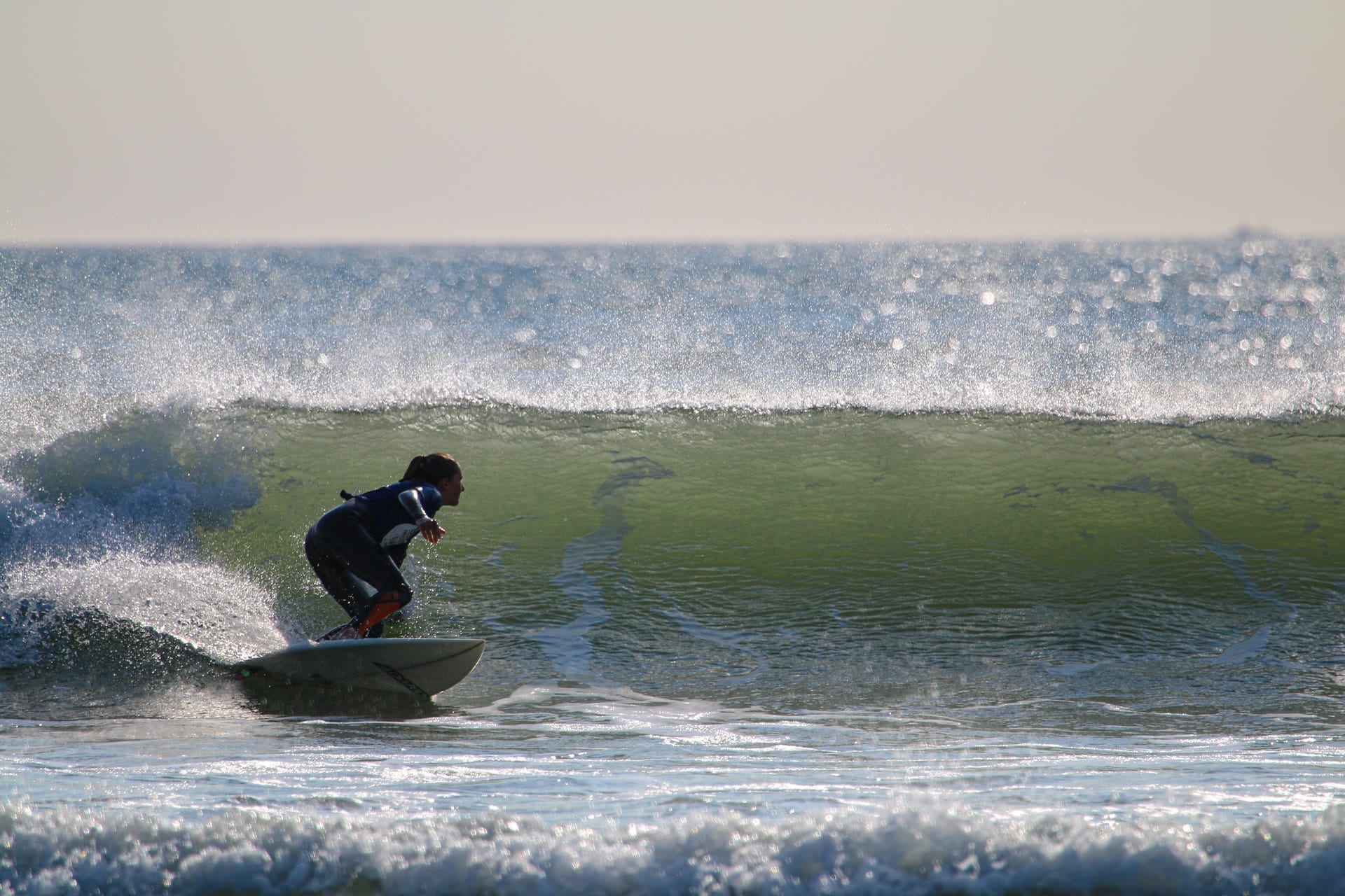 Croyde Bay surfer surfing across a wave