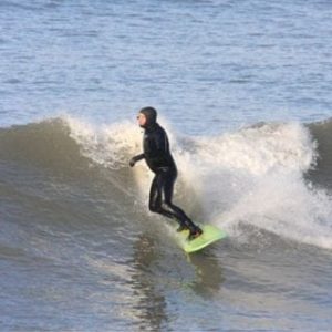 Surfing in a full wetsuit at Westward Ho!