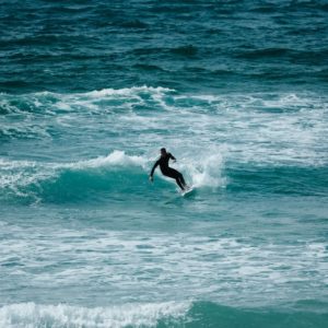 Surfer cutting back on waves at Fistral beach, newquay, cornwall