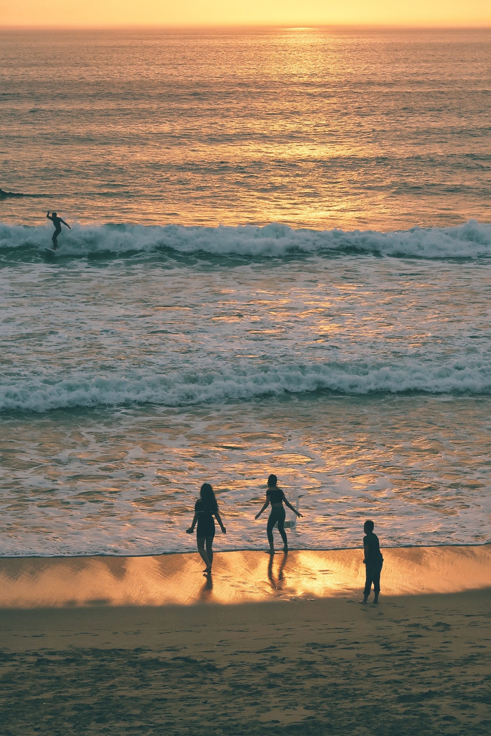 Surfing in the sunset at firstral beach in newquay, cornwall