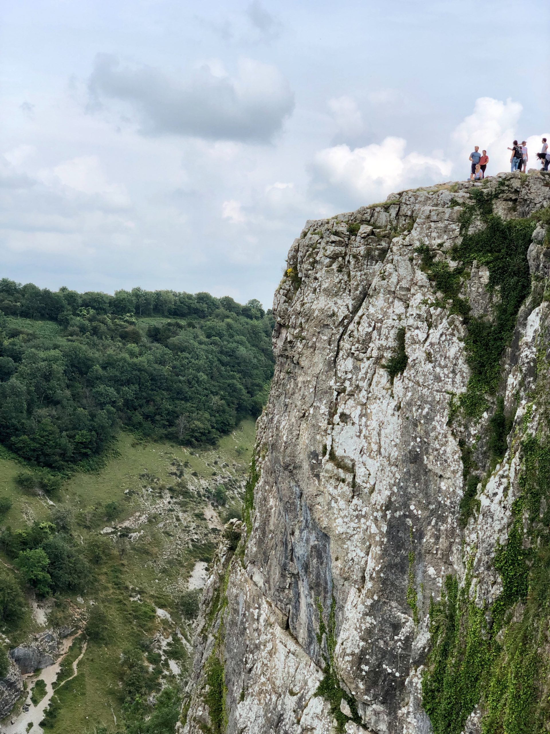 People standing at the top of rocks at cheddar gorge
