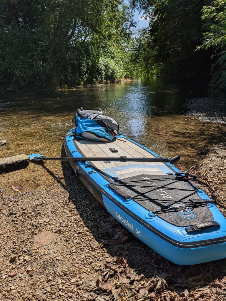 Paddle board sitting in the river thames at cricklade before the paddle boarding the thames journey