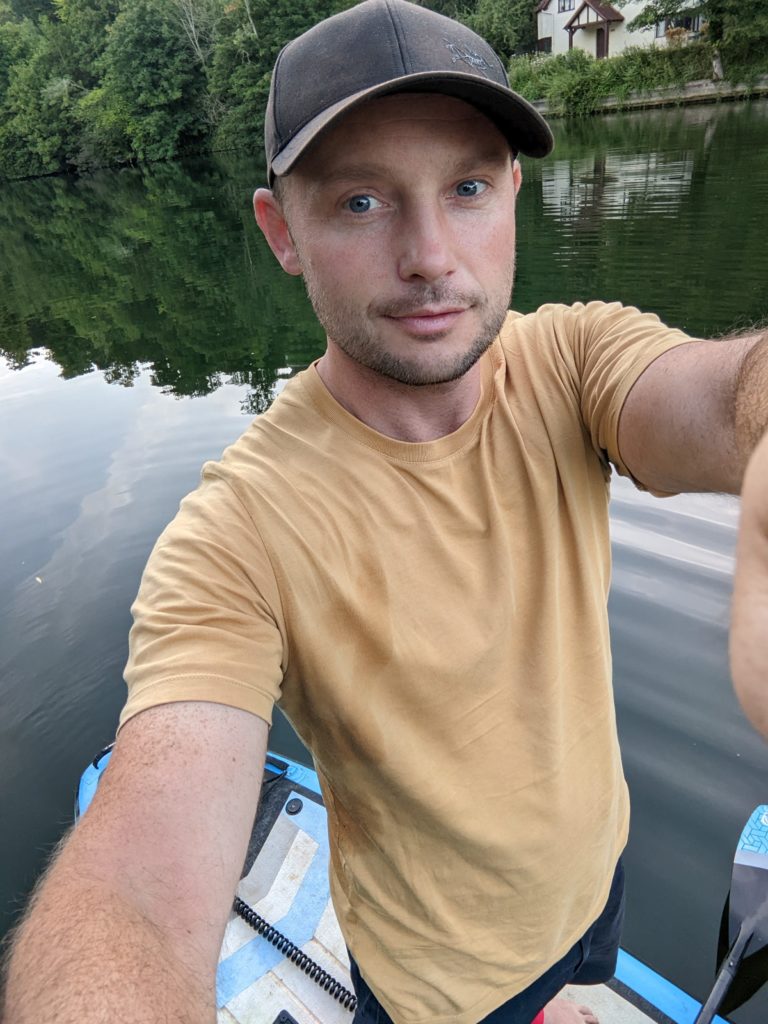 Tom paddle boarding the thames, on the river