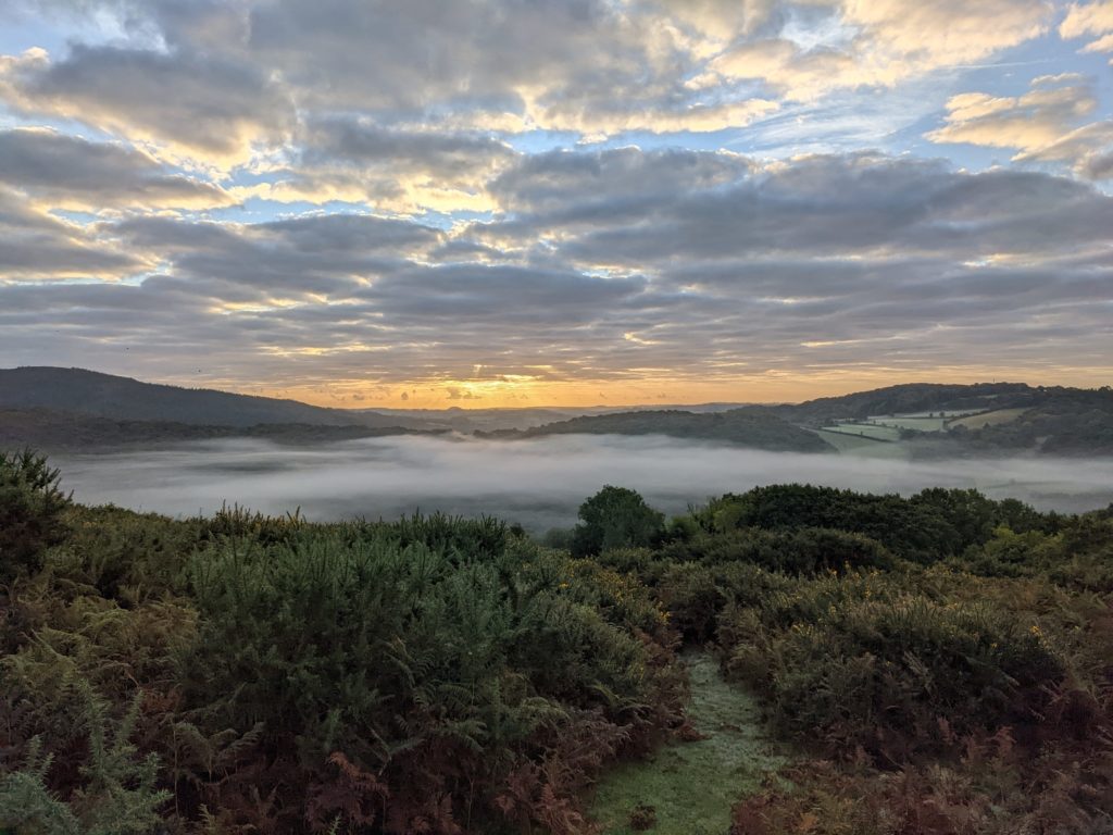 Morning looking across holne valley in dartmoor with mist in valley