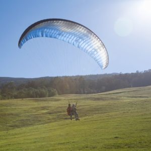 Paragliding in London in the sky and about to land in a field